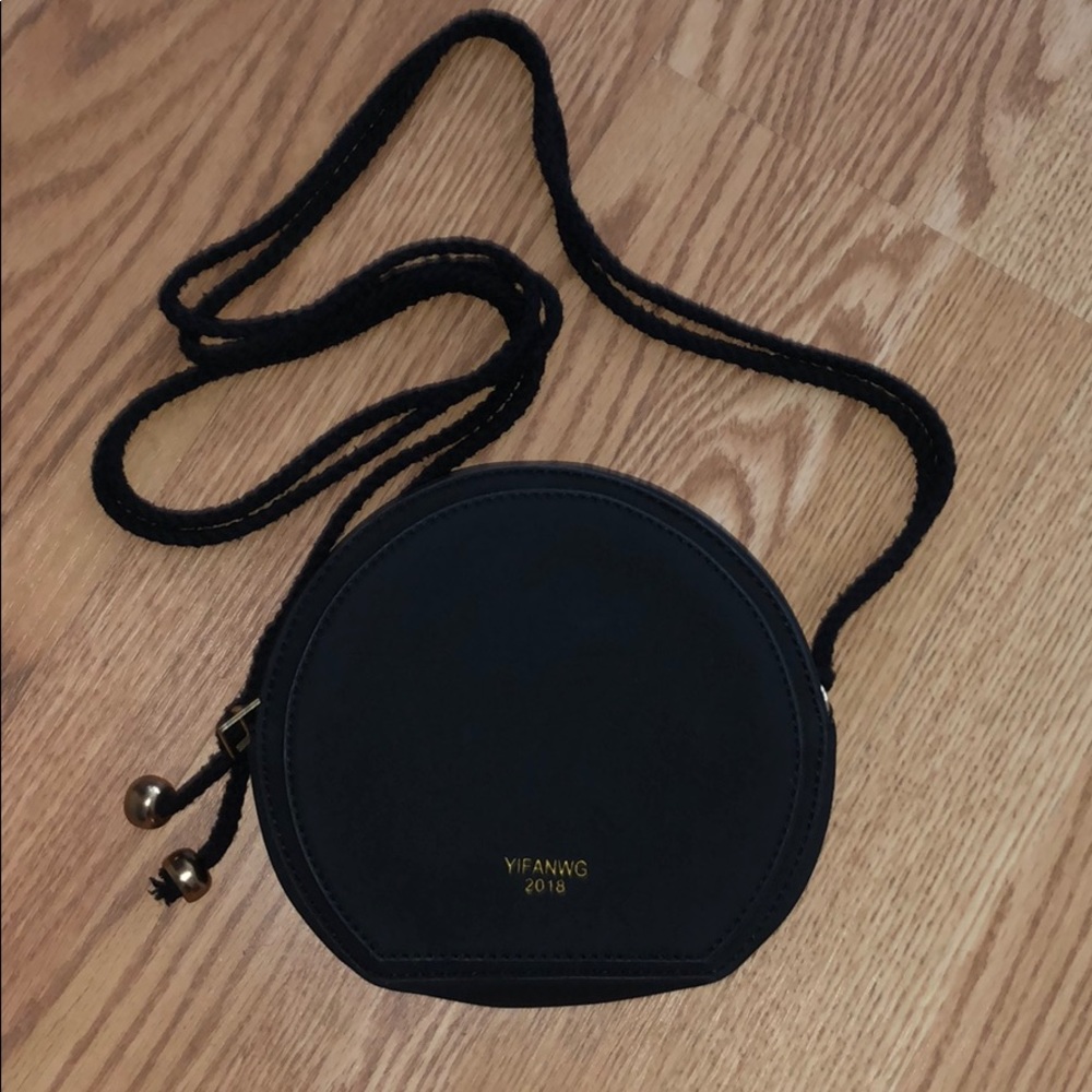 Black round cross body bag w gold accents